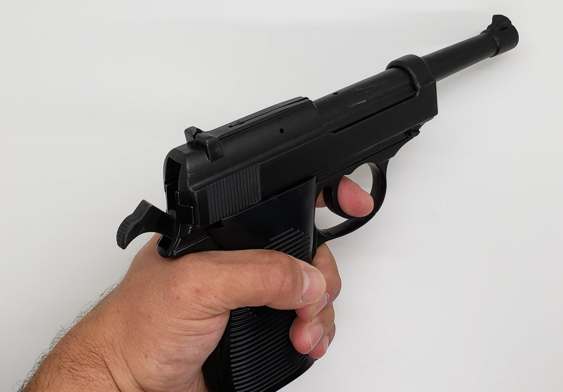 hand holding a non-firing replica pistol